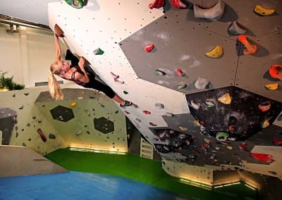 huge roof indoor bouldering gym girl climber